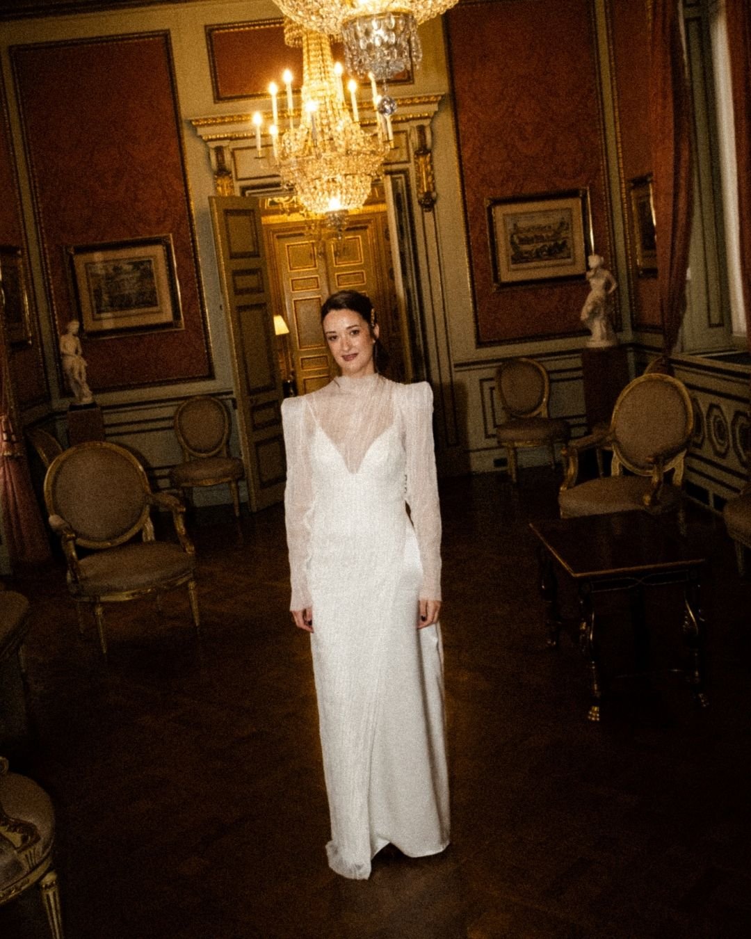 Ana en el salón histórico de Barcelona — sobrevestido de bambula plisada sobre base de satén de seda